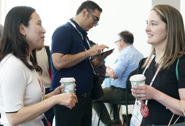 Two female conference attendees talking